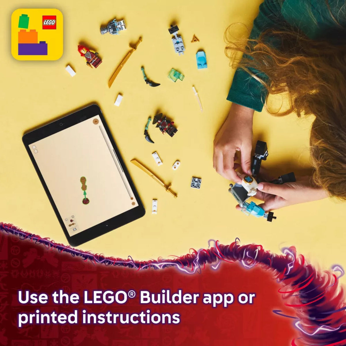 Child playing with LEGO bricks on a yellow surface with a tablet displaying instructions.