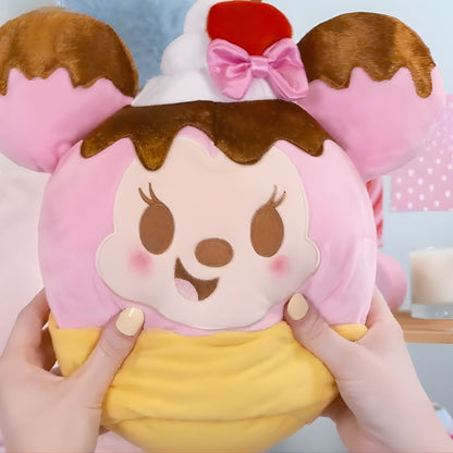 Lifestyle image showing a person's hands gently squeezing the ultra-squishy 10-inch Disney Munchlings Squeeze-A-Munch Minnie Mouse plush.