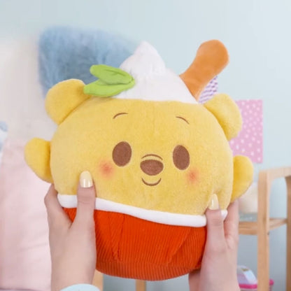 Lifestyle image showing a person's hands gently squeezing the ultra-squishy 10-inch Disney Munchlings Squeeze-A-Munch Winnie the Pooh plush.