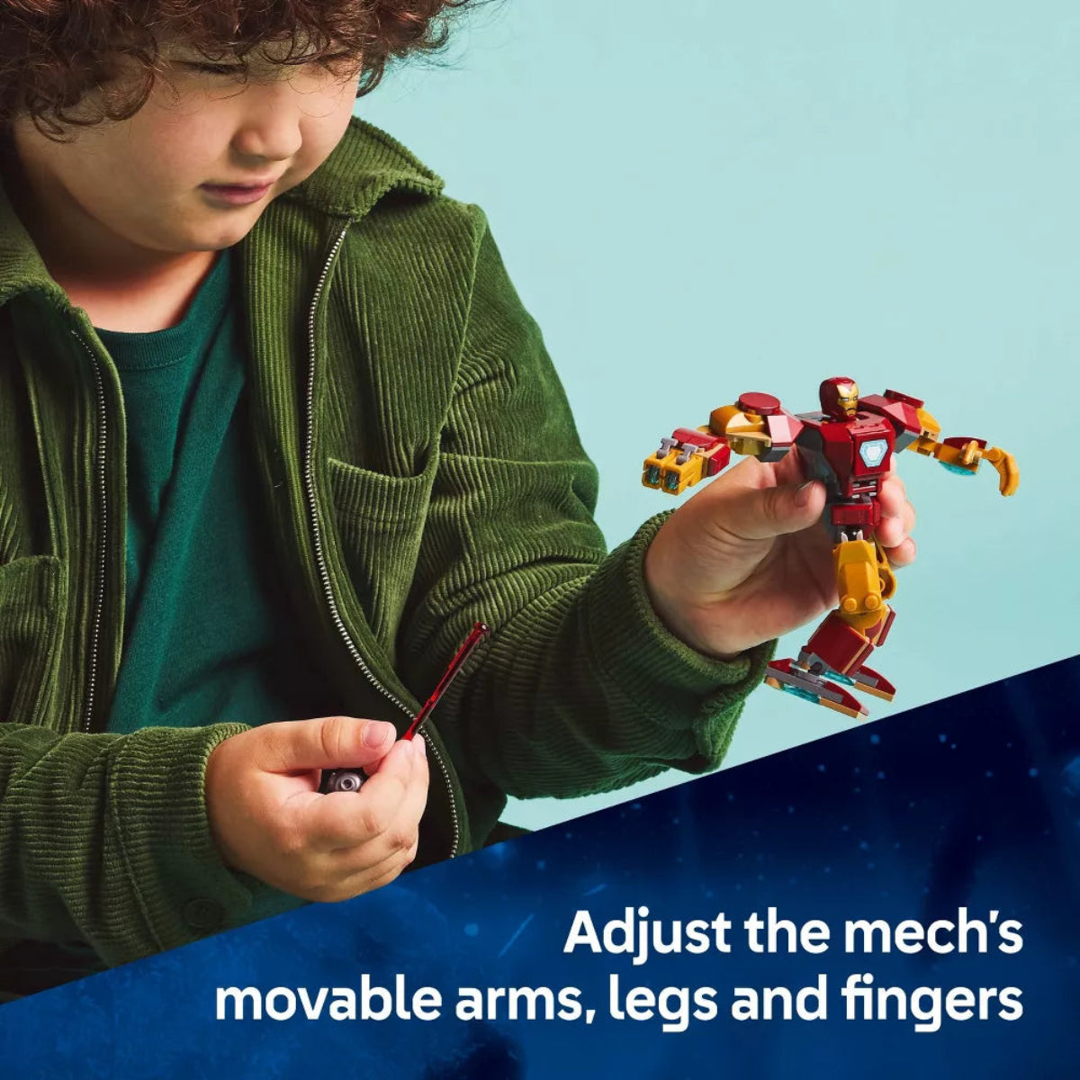 Child playing with a toy robot against a blue background