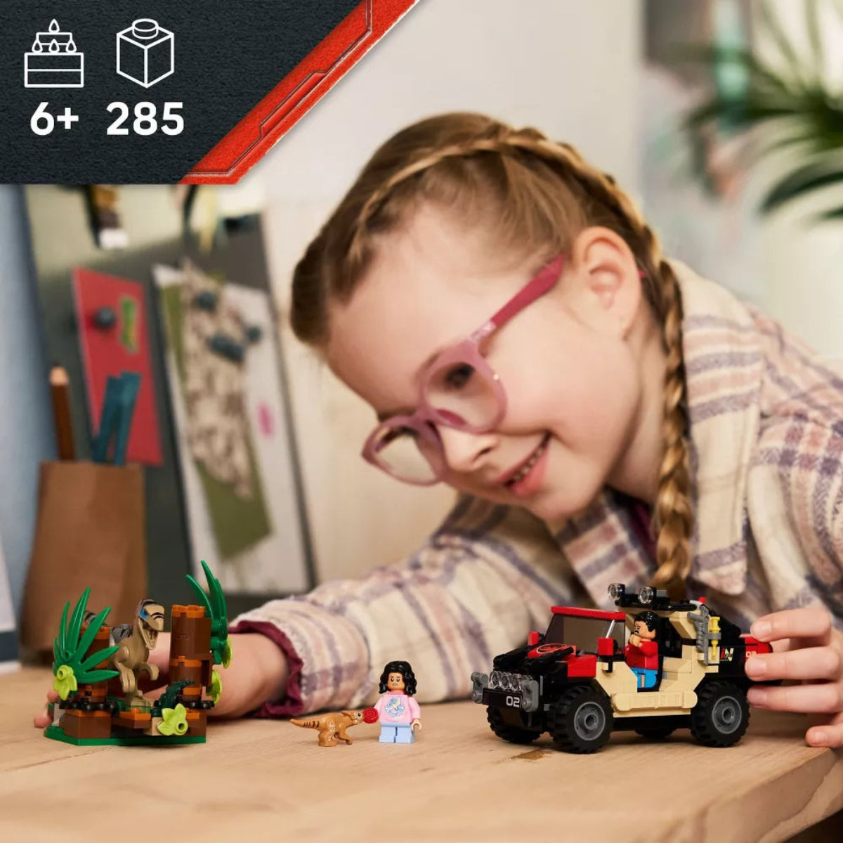 Child playing with LEGO sets on a table, with a focus on creativity and fun.