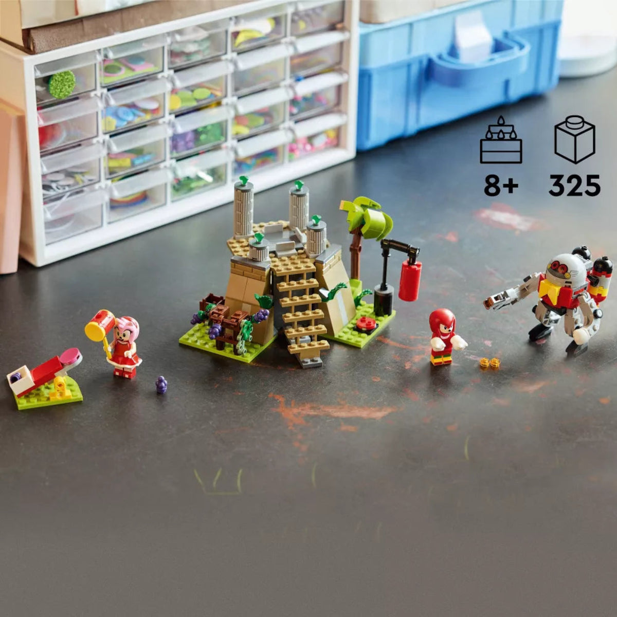 Toy building set with characters on a table, with storage units in the background.