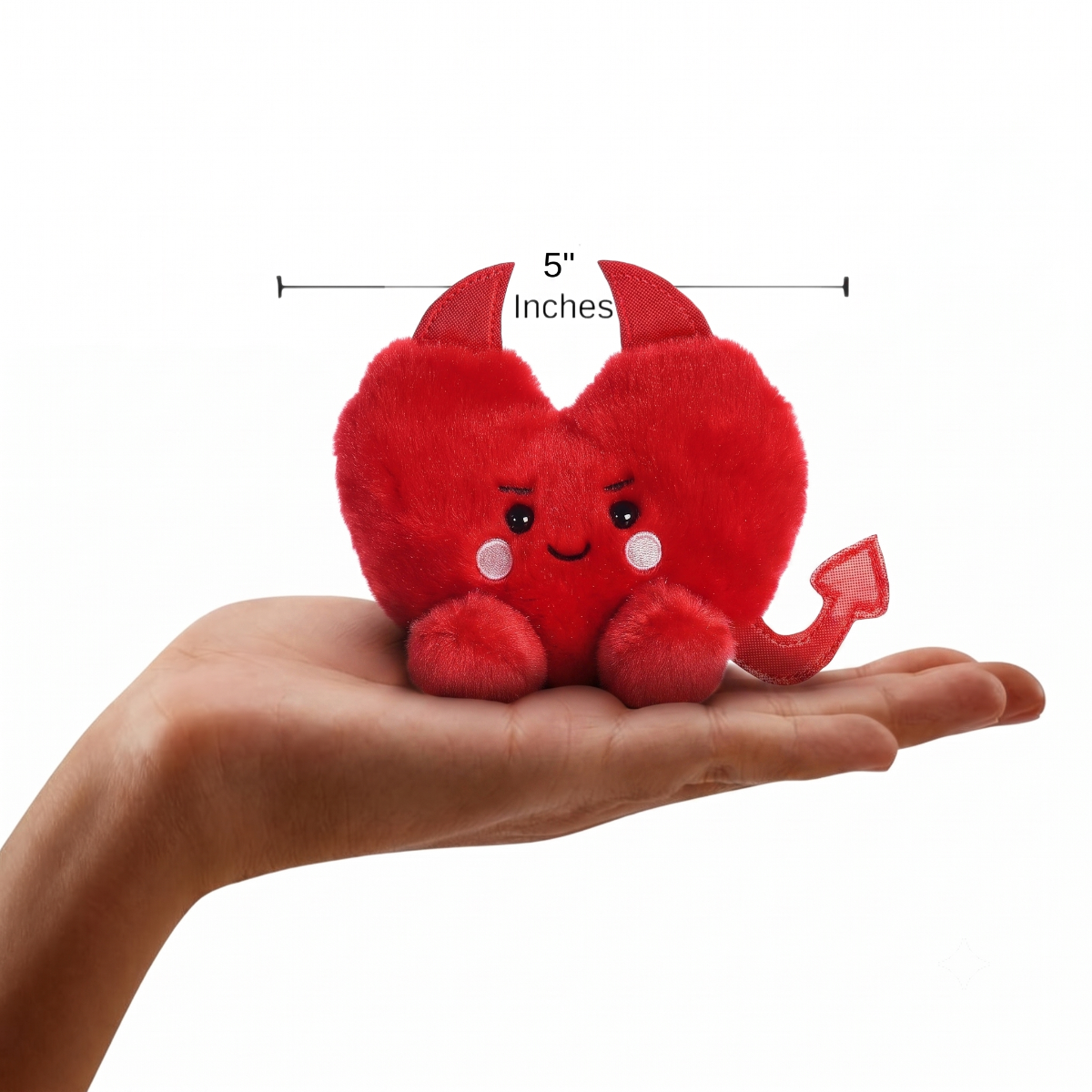 The miniature Klaus Heart plush sitting balanced in an open human hand under a 5-inch width graphic indicator.