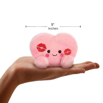 The miniature heart plush sitting balanced in an open human hand under a 5-inch height graphic indicator.