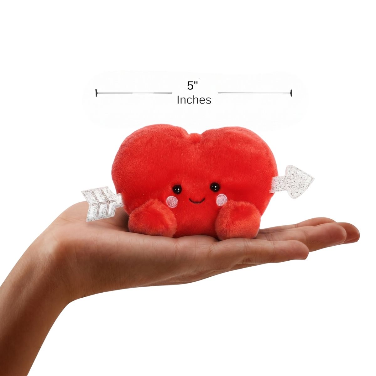 The miniature Paolo Cupid Heart plush sitting balanced in an open human hand under a 5-inch width graphic indicator. 