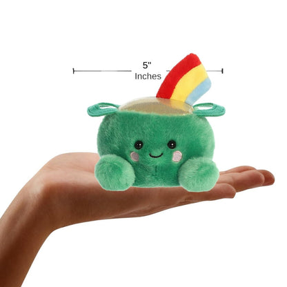 Hand holding the Ciara Pot of Gold plush to demonstrate its palm-sized scale, with a measurement graphic indicating it is 5 inches wide.
