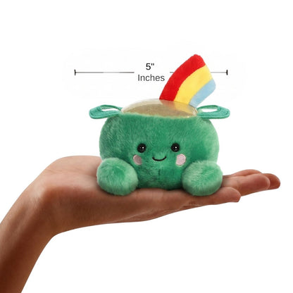The miniature green pot of gold plush sitting balanced in an open human hand under a 5-inch height graphic indicator.