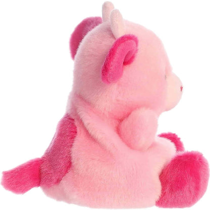 Side profile view of the Palm Pals Blossom Pink Cow plush highlighting its plump, rounded shape and little pink tail.