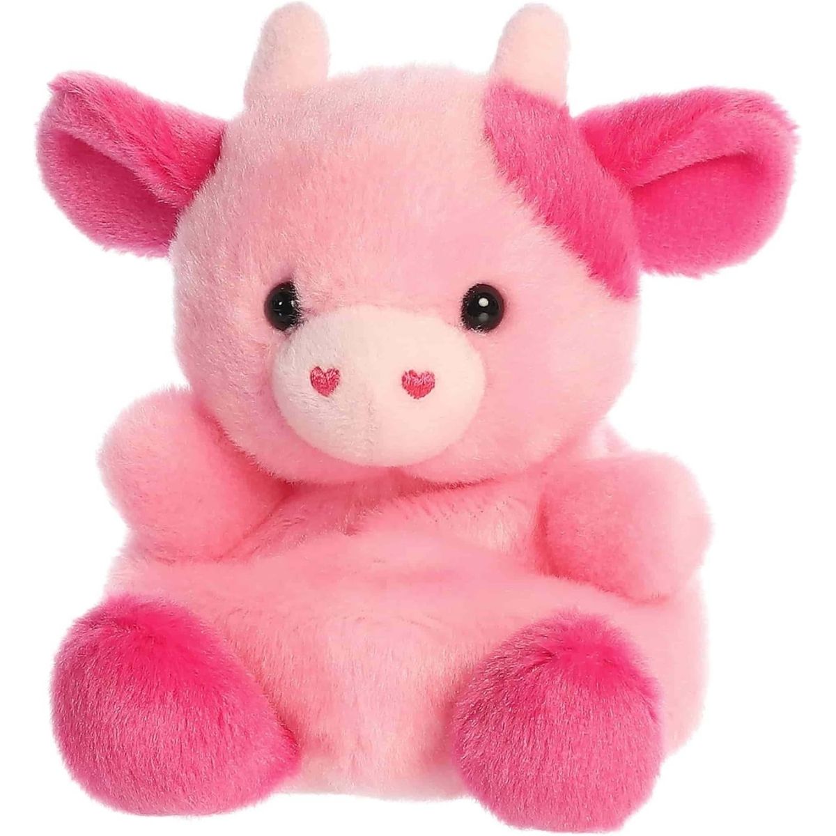 Angled front view of the sweet pink cow plush sitting happily on its little plush hooves.