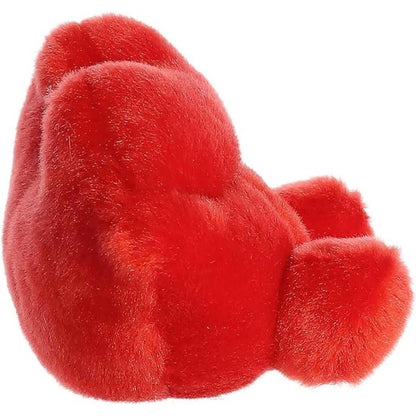 Side profile view of the Palm Pals Kissie Lips plush highlighting its rounded, plush texture and small feet resting on the surface.