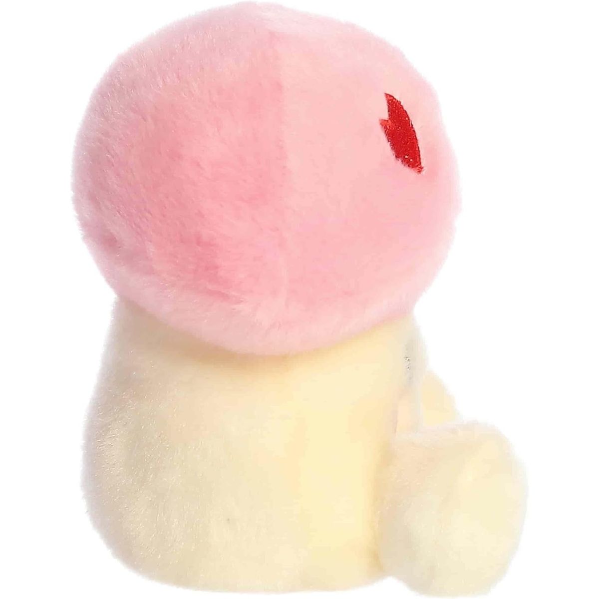 Back view of the Aurora mushroom plush showcasing the pastel pink cap and its soft pale yellow body from behind.
