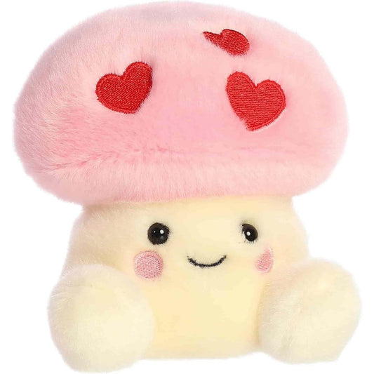 Straight front view of the sitting Valentine mushroom plush showing its pale yellow body, embroidered smile, and rosy pink cheeks.