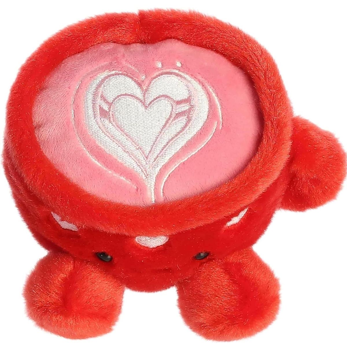 Top-down angled view of the Lotti Love Latte plush revealing the beautiful pink and white heart-shaped latte art on top.