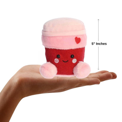 Sizing graphic showing the 5-inch Palm Pals Parker Heart Coffee plush sitting perfectly in the palm of a hand to demonstrate its small scale.