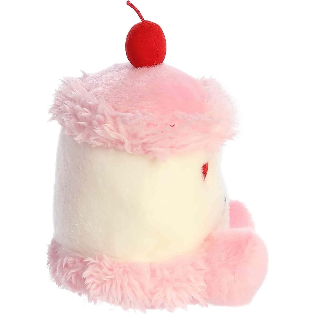 Side profile of the Aurora Palm Pals Jubi Heart Cake plush highlighting its fluffy pink frosting and round shape.