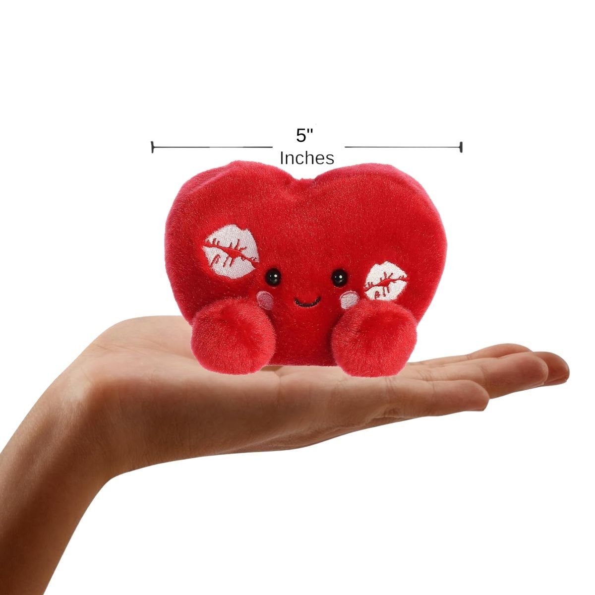 Sizing graphic showing the 5-inch Palm Pals Kimi Kisses Heart plush sitting perfectly in the palm of a hand to demonstrate its small scale.