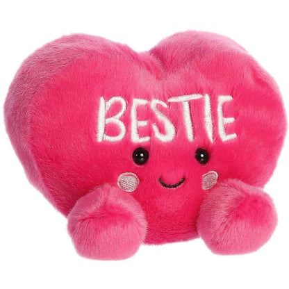 Front view of the 5-inch Aurora Palm Pals Bestie Candy Heart plush toy featuring a bright pink heart shape with white BESTIE text and a smiling face.