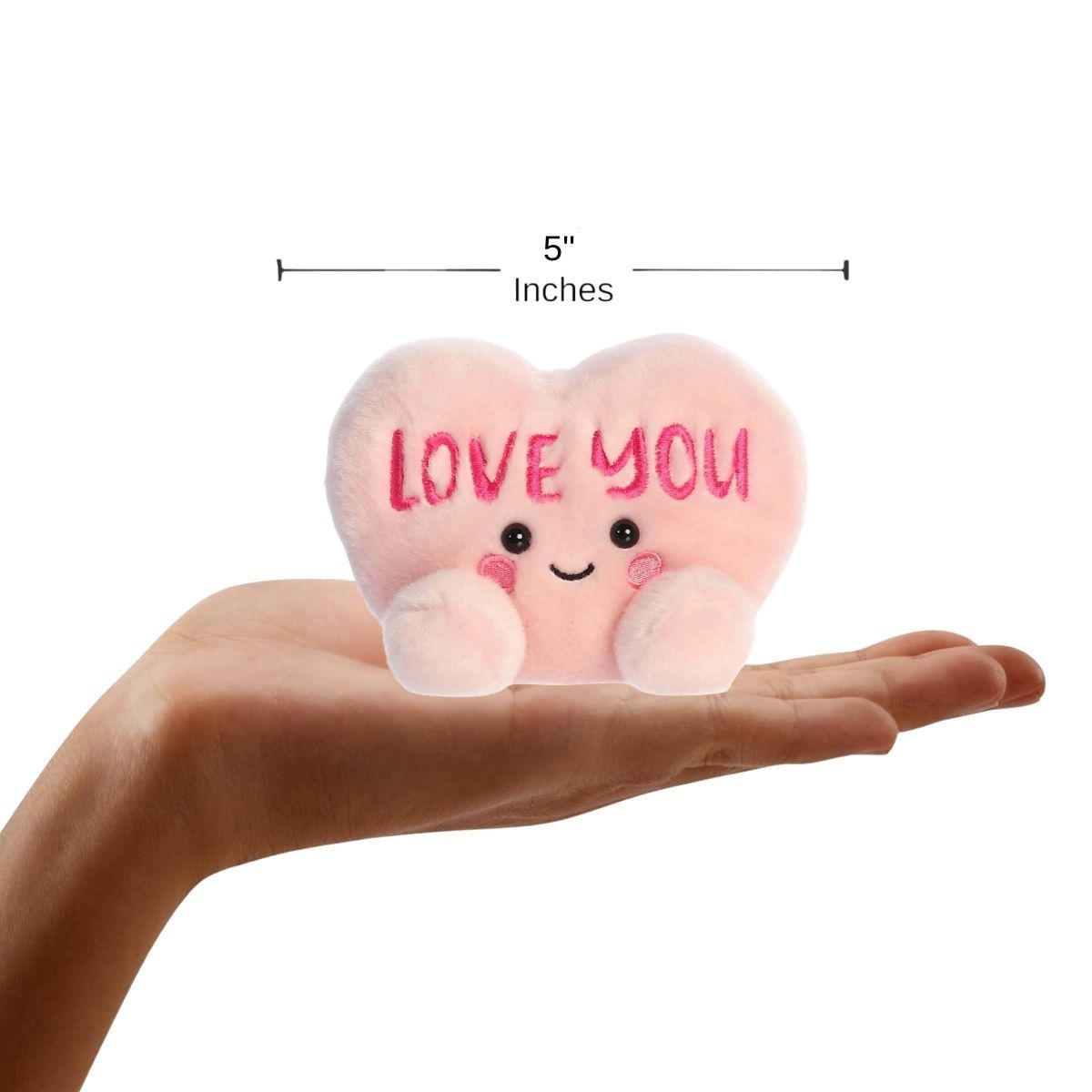 Sizing graphic showing the 5-inch Palm Pals Love You Candy Heart plush sitting perfectly in the palm of a hand to demonstrate its small scale.