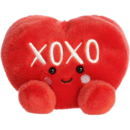 Straight front view of the sitting red plush heart showing the embroidered XOXO text, black eyes, and rosy pink cheeks.