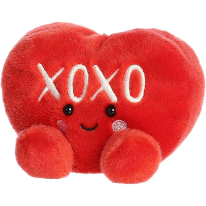 Angled front view of the smiling XOXO plush heart sitting happily on its little plush bottom.