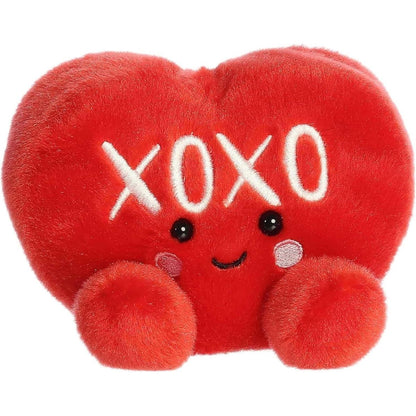 Front view of the 5-inch Aurora Palm Pals XOXO Candy Heart plush toy featuring a bright red heart shape with white XOXO text and a smiling face.
