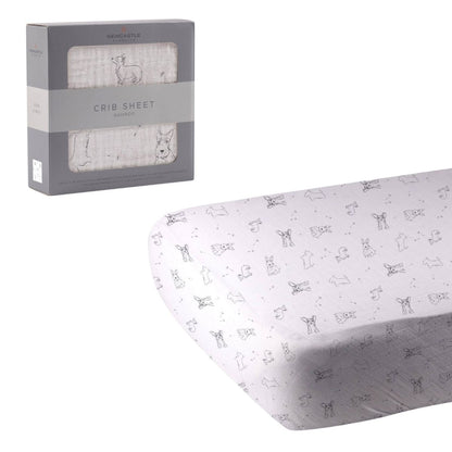 Newcastle Classics Corgi and Scottie puppy print bamboo crib sheet unrolled next to its grey retail window box.