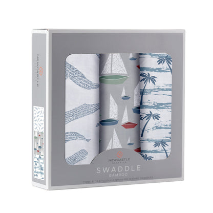 Angled front view of the Newcastle Classics 3-pack swaddle blanket set folded inside a light grey window display box.