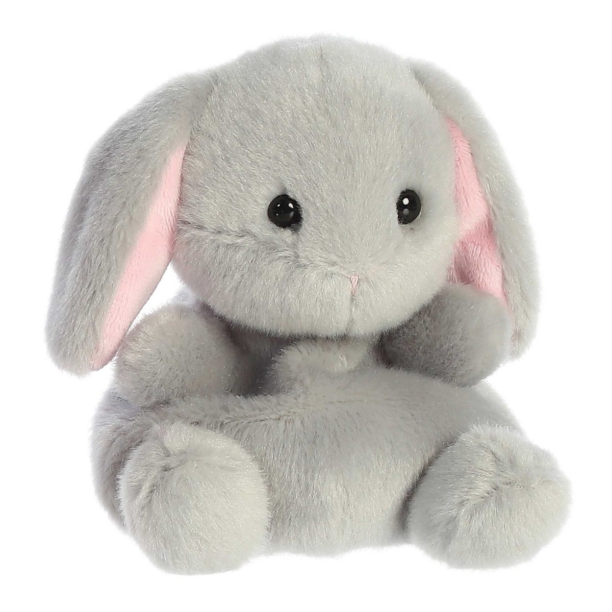 Angled view of the Aurora Palm Pals 5-inch Pebbles Bunny plush sitting upright, showing its soft grey fur and floppy ears with pink insides.