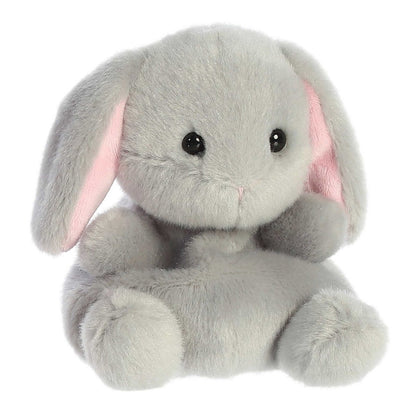 Angled view of the Aurora Palm Pals 5-inch Pebbles Bunny plush sitting upright, showing its soft grey fur and floppy ears with pink insides.