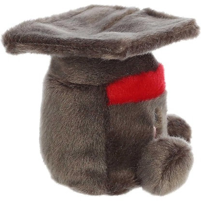 Right side profile view of the cap plush showing its flat square mortarboard top and rounded base with a red band accent.
