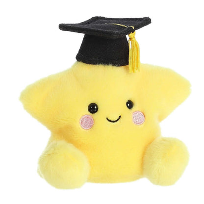 Angled view of the soft yellow Palm Pals star stuffed toy featuring pink rosy cheeks and a smiling face.