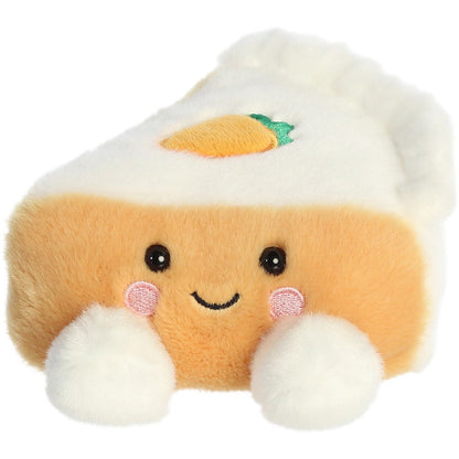 Aurora 5-inch Palm Pals Carrie Carrot Cake plush toy showing its triangular cake slice shape, light orange body, white frosting layers, tiny embroidered carrot on top, and smiling face.