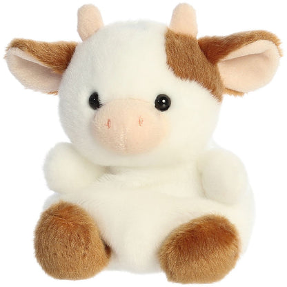 Slightly angled high front view of the sweet Palm Pals Caroline Cow plush looking up.