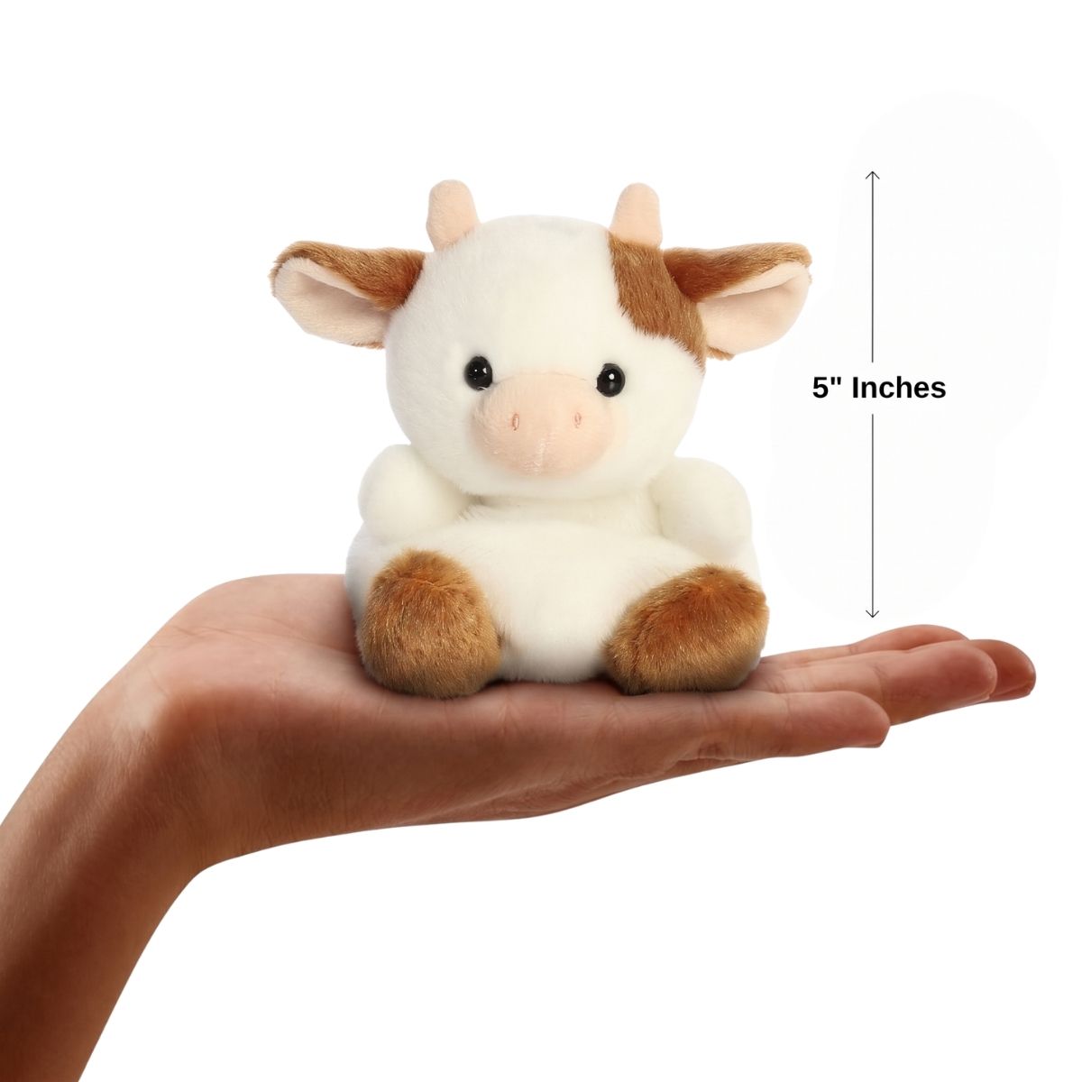 Sizing graphic for the Aurora Palm Pals Caroline Brown Cow plush showing it sitting perfectly in the palm of a hand, indicating a total height of 5 inches.