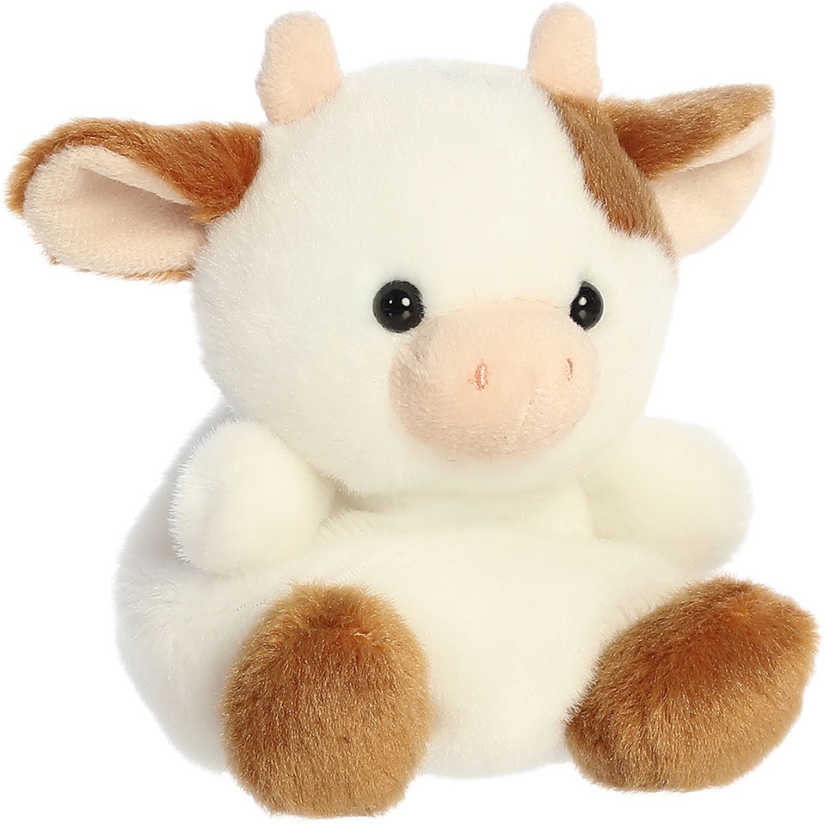 Angled view of the Aurora Palm Pals 5-inch Caroline Brown Cow plush sitting upright, showing her white fur, brown spot over one eye, and pink horns.