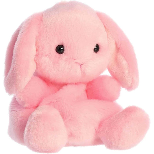 Angled front view of the soft light pink Palm Pals bunny plush sitting upright.