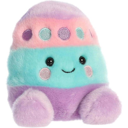 Angled front view of the soft Palm Pals Easter egg plush sitting upright with purple, pink, and teal colors.