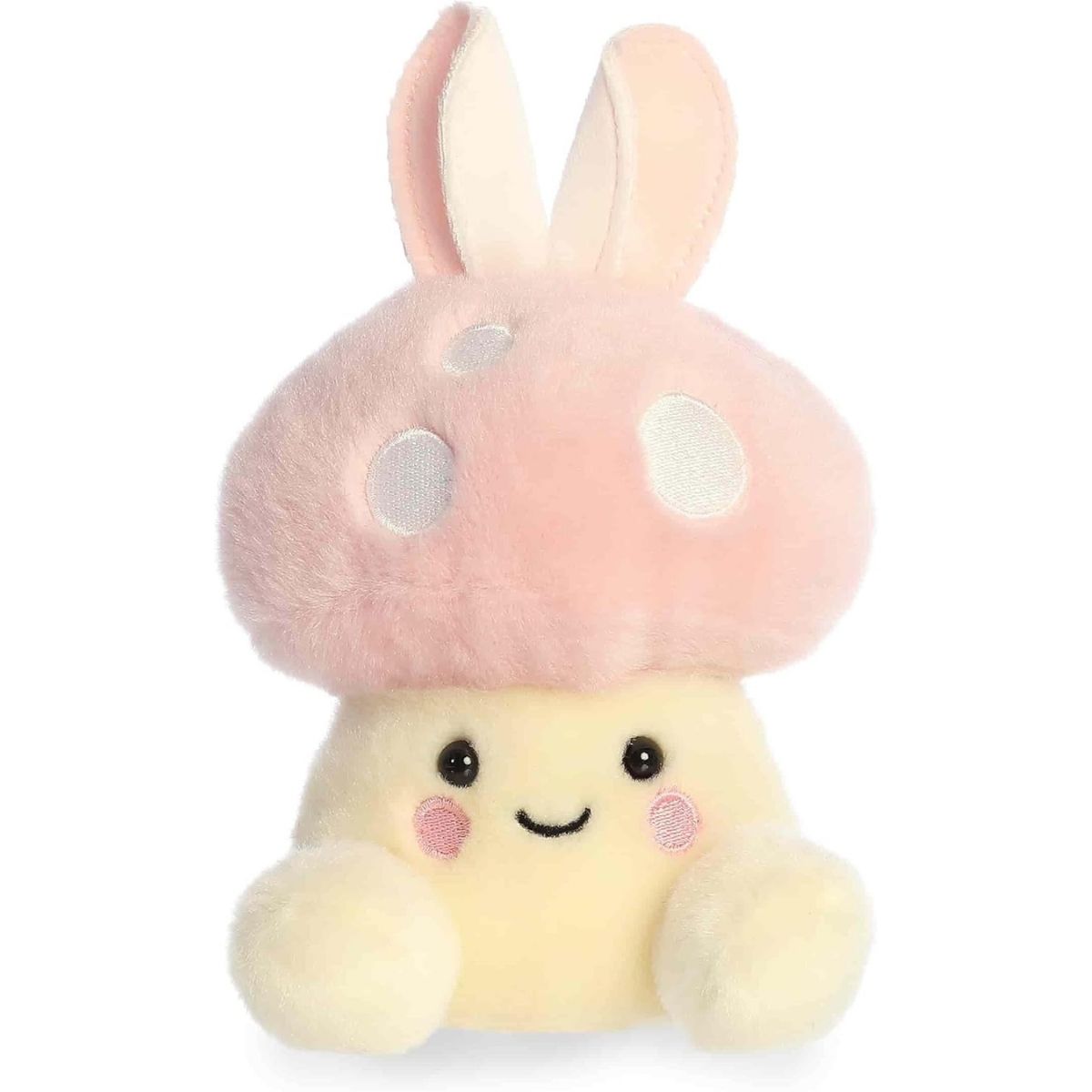 Straight front view of the sitting bunny mushroom plush showing its pale yellow body, embroidered smile, and rosy pink cheeks.