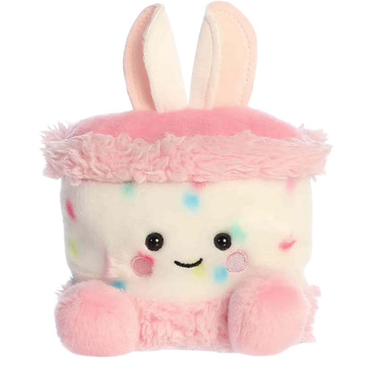 Front view of the Aurora Palm Pals 5-inch Bubbi Bunny Cake plush sitting upright, showing its speckled white body, pink frosting trim, and bunny ears.