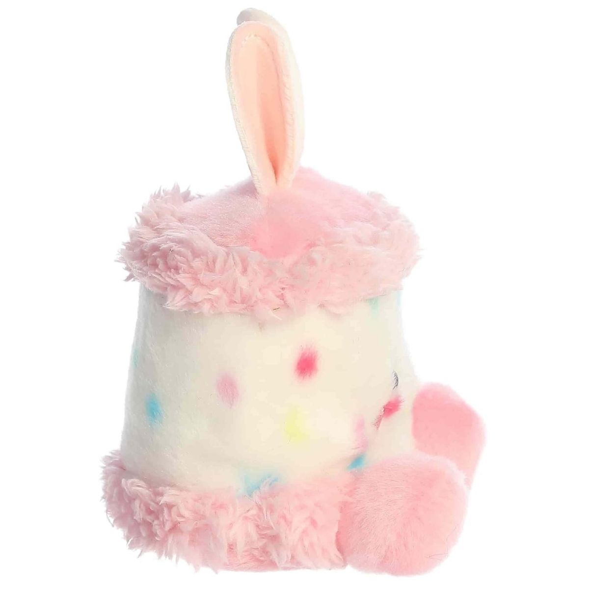 Side profile view of the Palm Pals Bunny Cake plush highlighting its perfectly squishy round body, fluffy pink trim, and tall bunny ears.
