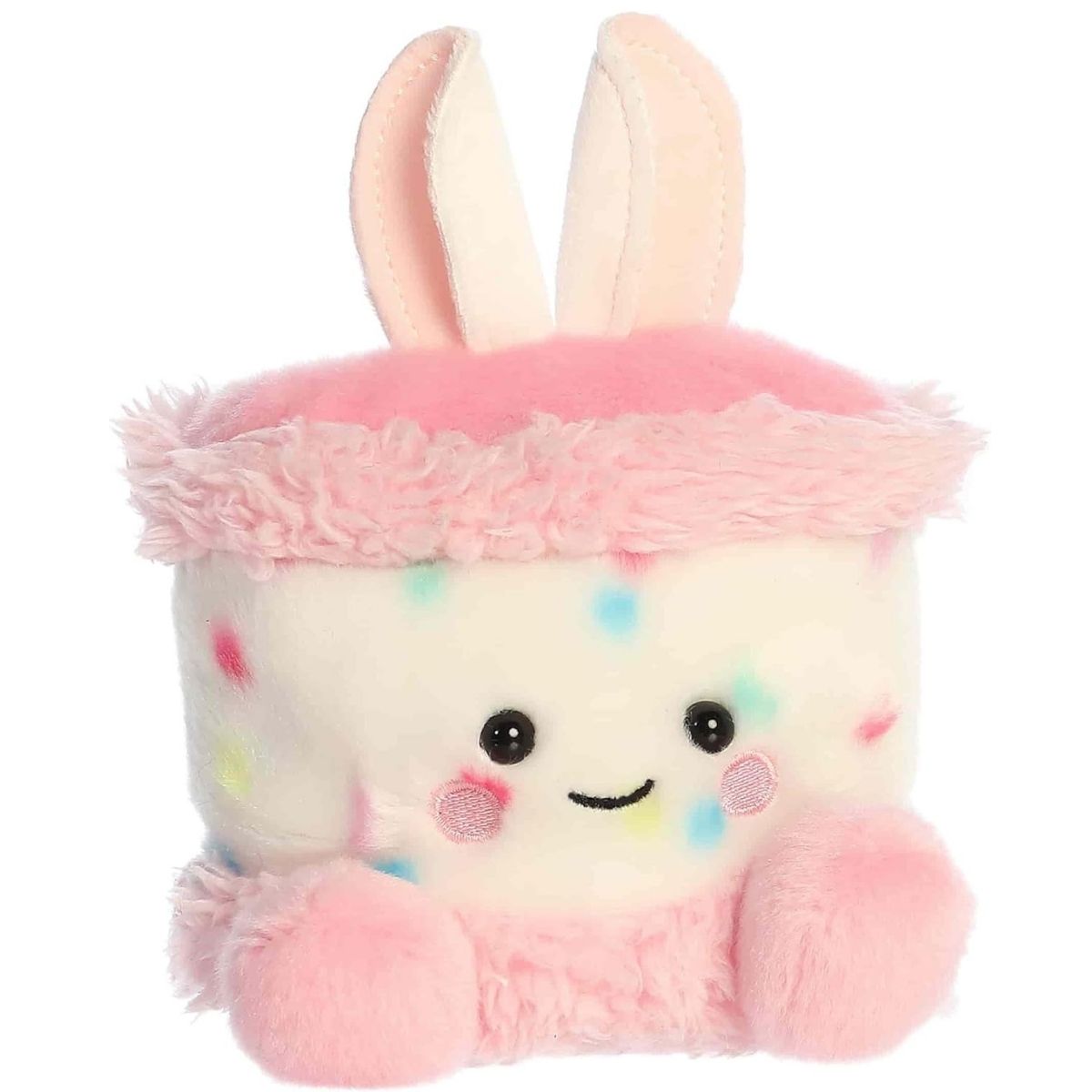 Angled front view of the adorable Aurora Bubbi Bunny Cake stuffed animal featuring a sweet smile, rosy pink cheeks, dark eyes, and soft pink feet.