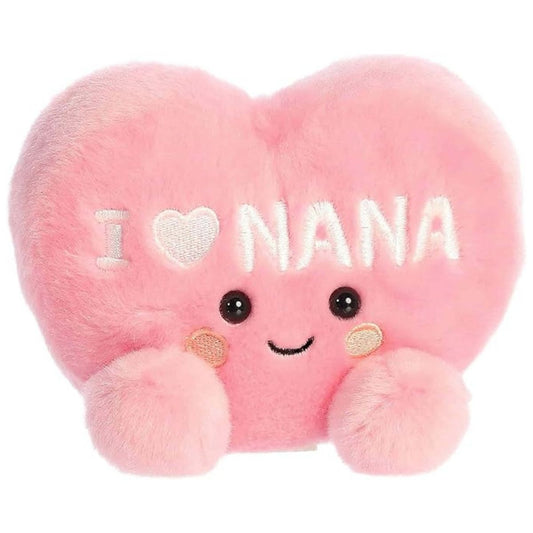 Angled front view of the soft pink Palm Pals I Love Nana Heart stuffed toy sitting upright.