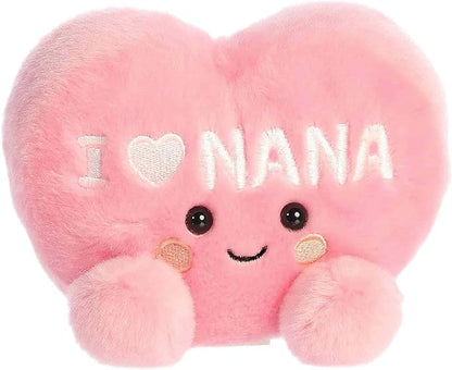 Close-up view of the cheerful Palm Pals I Love Nana Heart plush showing its smiling face and pink cheeks.