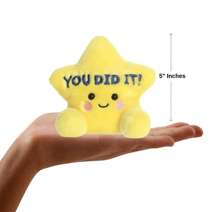 Sizing graphic showing the 5-inch Palm Pals star plush sitting perfectly in the palm of a hand to demonstrate its small scale.