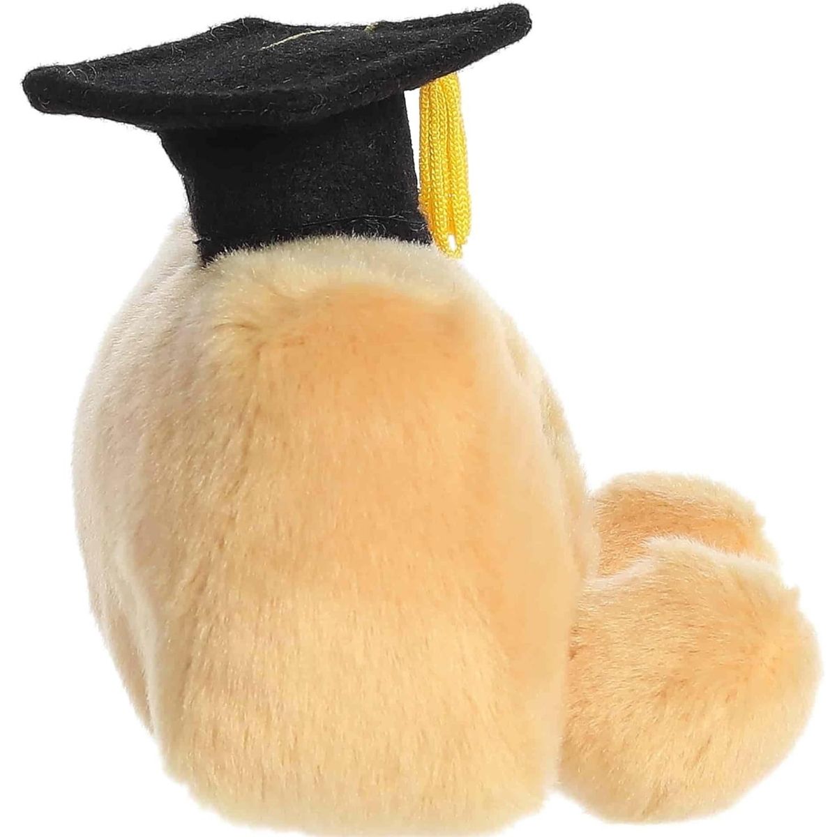 Side profile view of the Palm Pals ruler plush highlighting its plump, rounded shape and the black graduation cap with a yellow tassel.