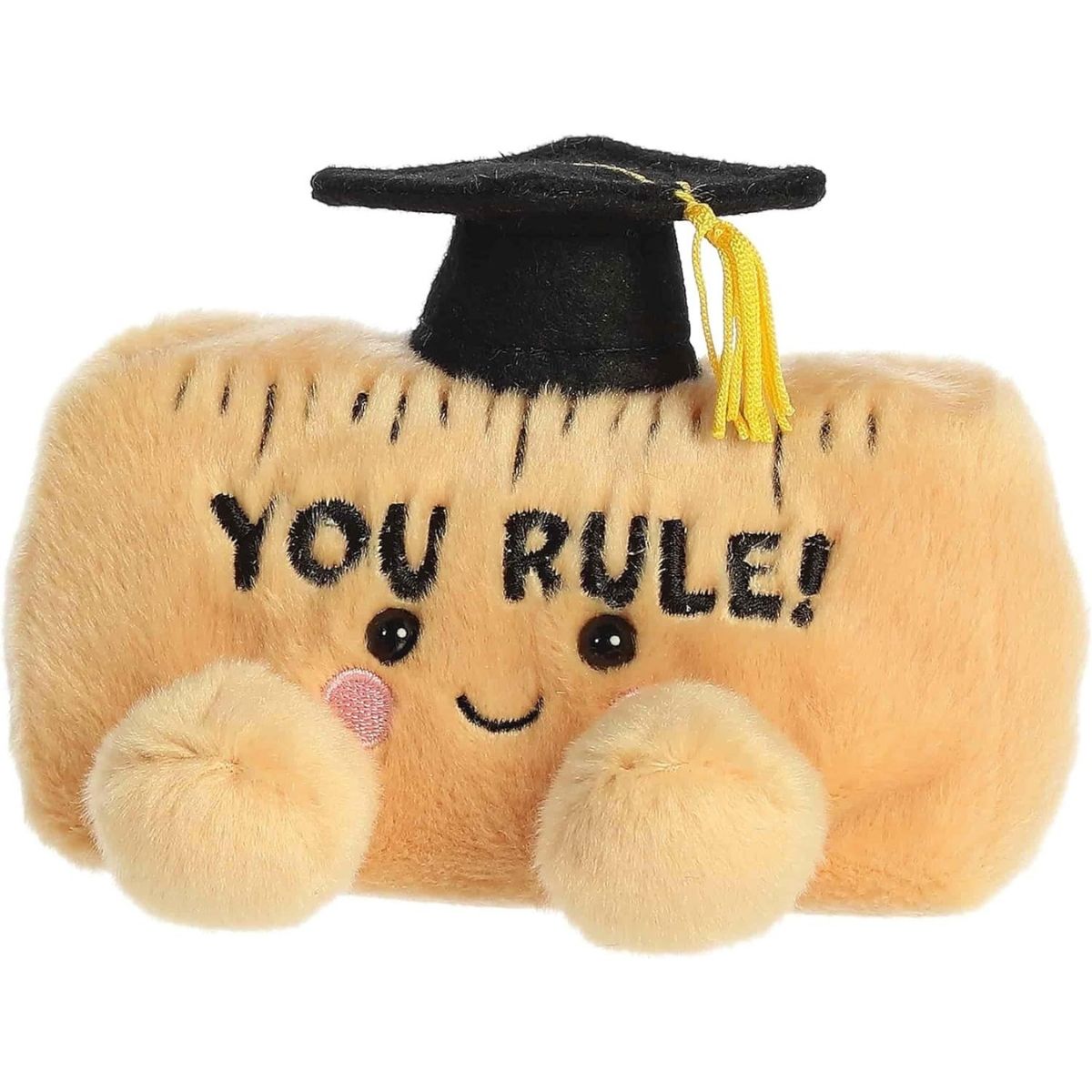 Angled front view of the smiling YOU RULE plush ruler sitting happily on its little plush feet.