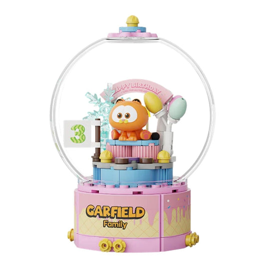 Pantasy Garfield mini-figure celebrating with a cake inside the clear crystal ball display.
