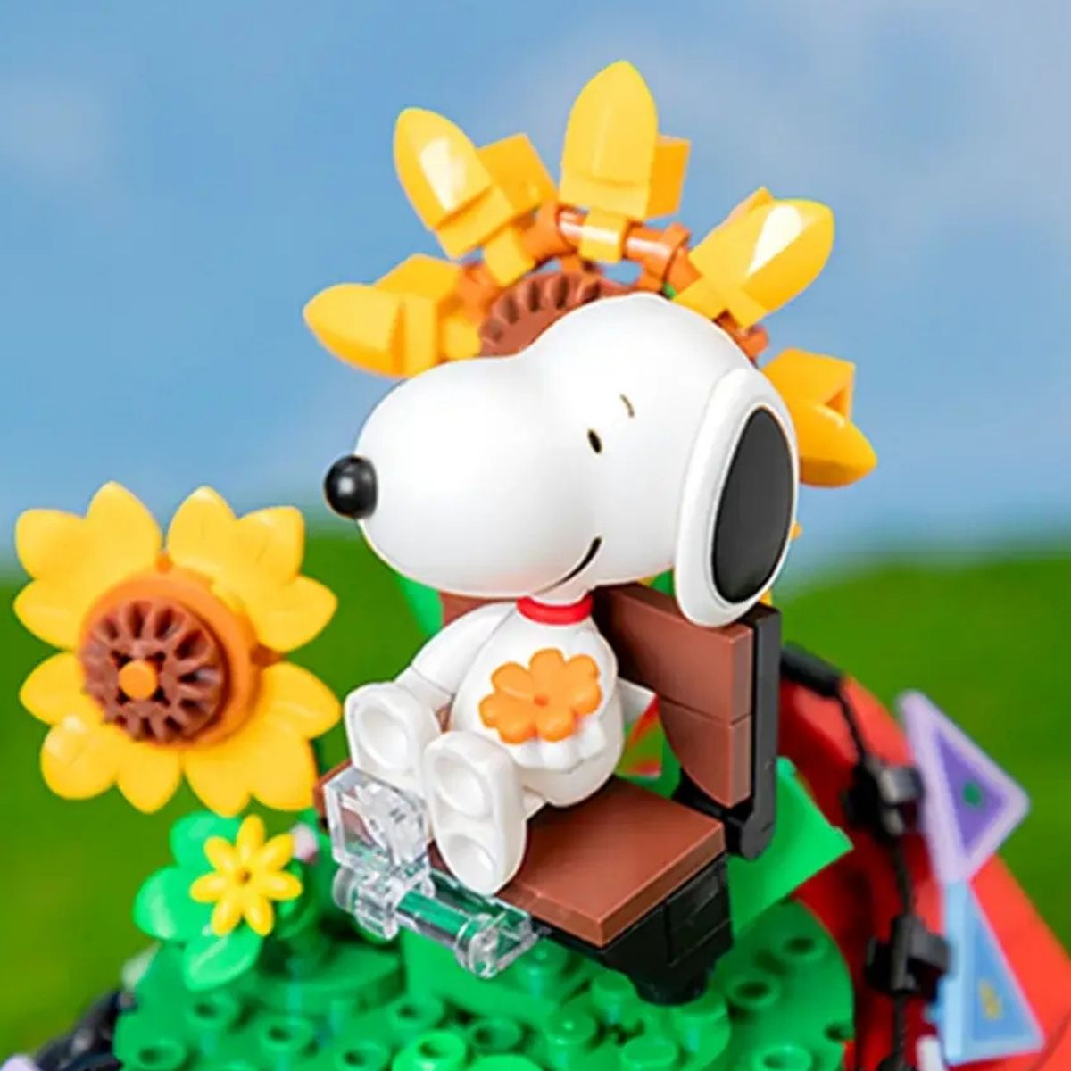 Close-up of the Snoopy and Woodstock figures sitting on top of the red doghouse roof.