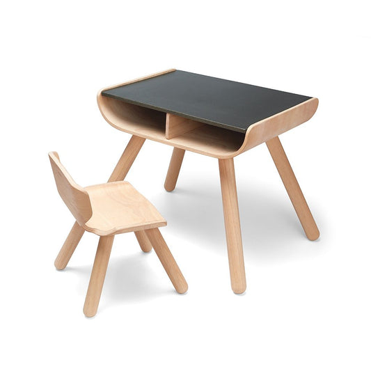 Front angle of the modern PlanToys wooden table and chair set featuring a sleek black tabletop and two storage cubbies.