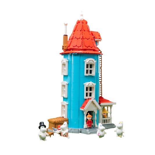 Completed Pantasy Moomin House building block set showing the blue exterior, red roof, and 6 minifigures gathered outside on the porch.